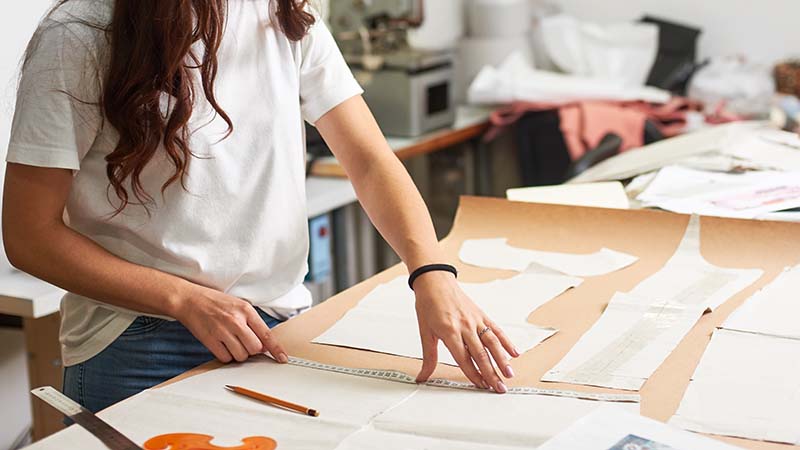 workplace,in,design,studio.,professional,female,designer,making,paper,patterns